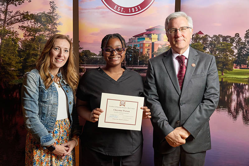 student with Dean Pratt and Program Director