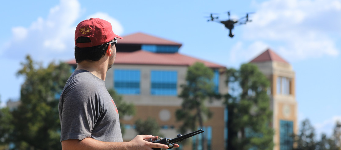 man piloting drone