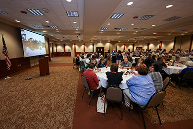 banquet room with projector and screen