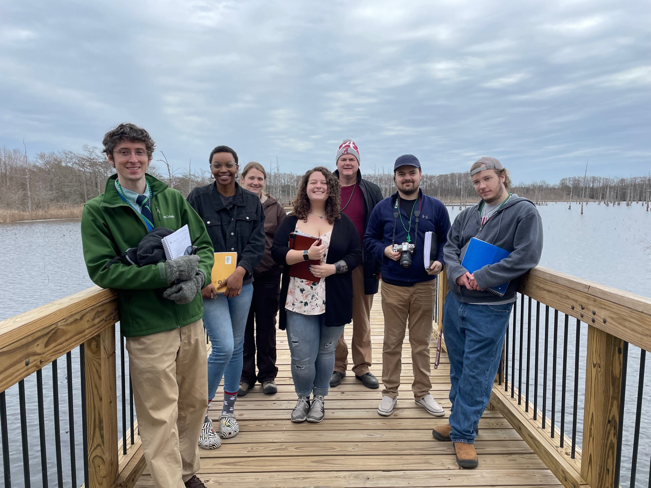 ULM students stand on a boardwalk at Black Bayou Refuge