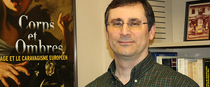 Dr. Chris Michaelides smiling in his office