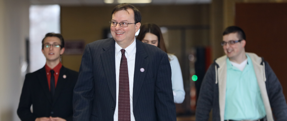 Photo of Berry with students walking